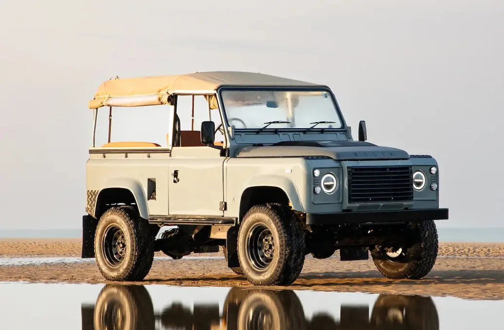 Relik electric Land Rover Defender on a beach — this vehicle has sold